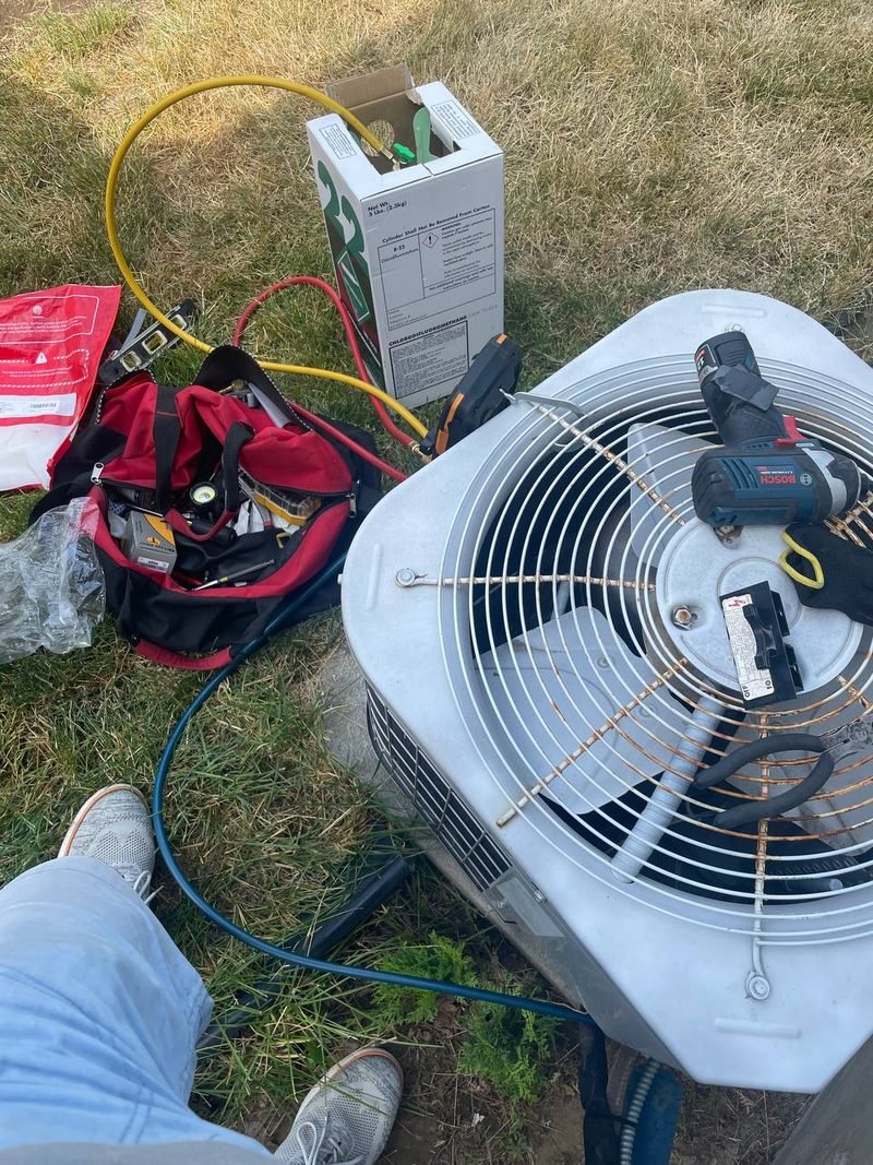 Outdoor AC condenser opened up for testing beside a Spokane house