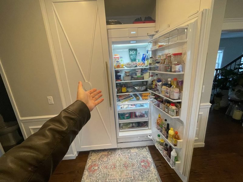 Built-in refrigerator open for diagnosis in a customer kitchen