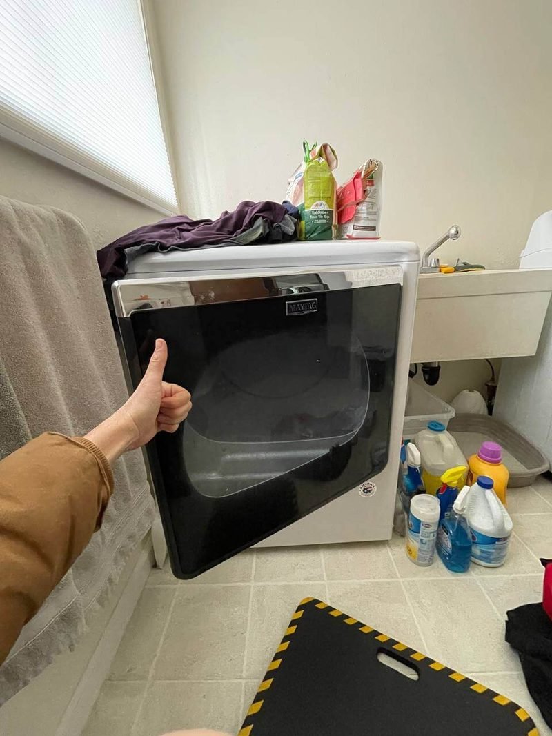 Front-load dryer in a laundry room before repair