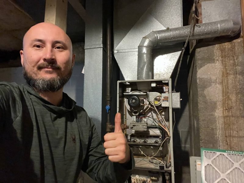 Our technician next to a furnace he just repaired