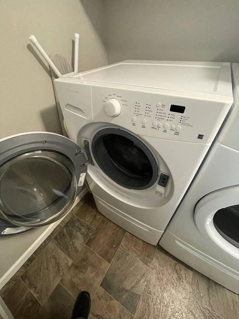 Front-load washer in a laundry room on a repair call
